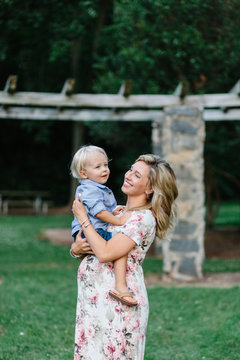 Pregnant mother with her young son sitting on er belly bump
