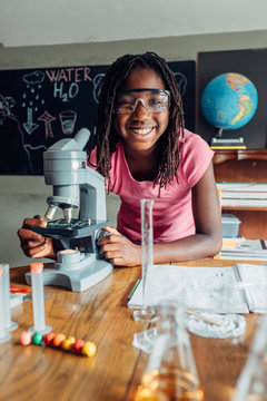 Smiling girl doing a chemistry experiment