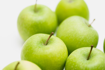 Close up shot of organic green yellow Granny Smith or Golden Delicious apples with little blemishes on white background