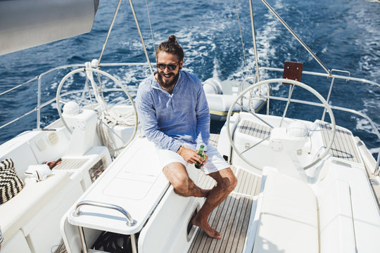 Man Enjoying Summertime on Sailboat