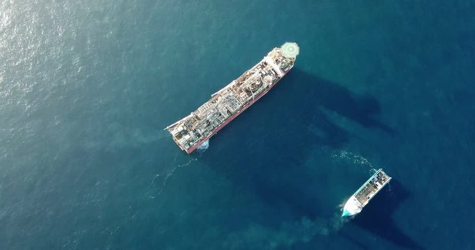 Aerial view of an offshore oil installation and supply ship