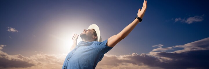 Composite image of happy man raising his arms up 