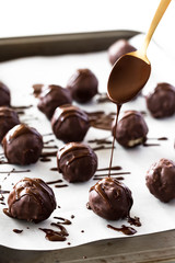 Melted Chocolate Dripping from the Golden Spoon on Chocolate Covered Vegan Balls