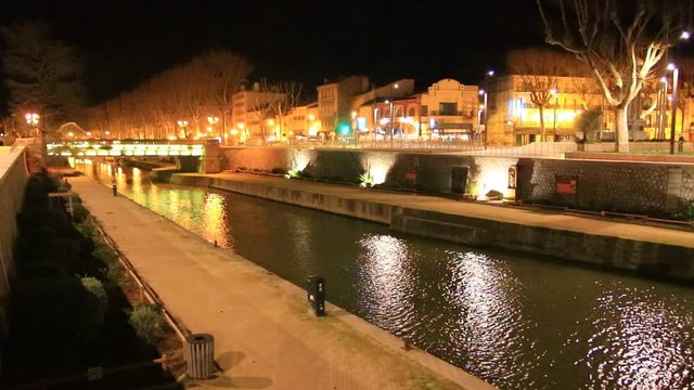 Quai on the edge of the Canal du Midi in the city of Narbonne at night, Aude in southern France
