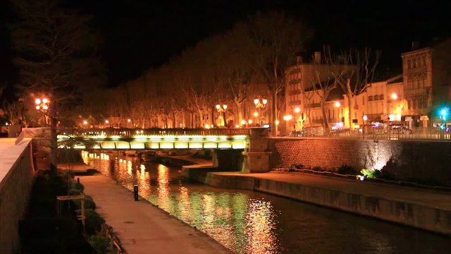 Quai on the edge of the Canal du Midi in the city of Narbonne at night, Aude in southern France
