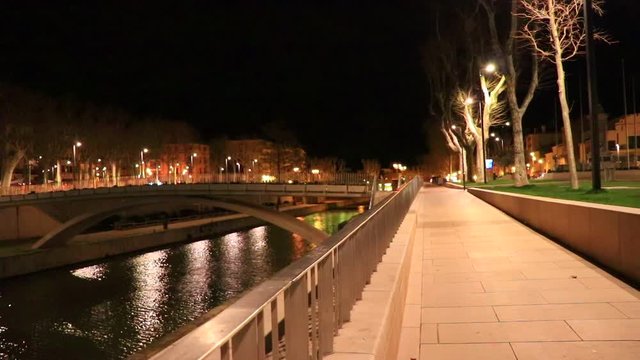Quai on the edge of the Canal du Midi in the city of Narbonne at night, Aude in southern France
