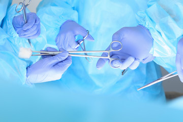 Close-up of unknown surgeons at work while operating at hospital. Health care and veterinary concept