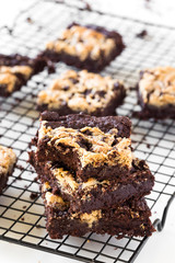 Chocolate Tahini Brownies Stacked in a White Table Bitten Off