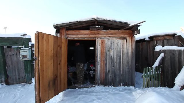 An old man walks into the barn