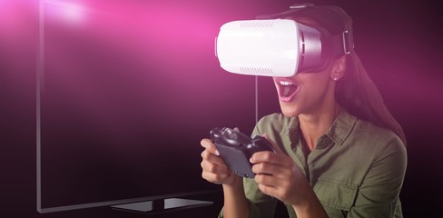 Naklejka premium Composite image of woman playing video game with virtual reality
