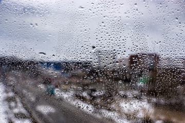 Blue water drops on window glas background