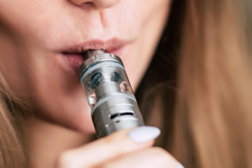 Closeup detail of Female with an Electronic Cigarette, Horizontal shot