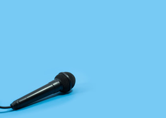 Black Microphone on blue background.