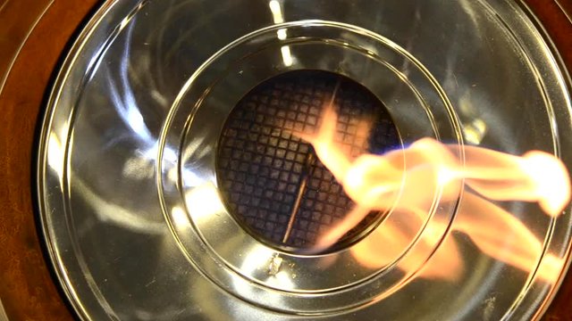 One Biofireplace burn on ethanol gas. Contemporary mount biofuel on ethanol fireplot fireplace close-up. Flame gas stove close-up. Modern ecological technologies. Interior design of a house inside