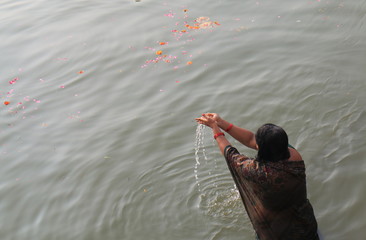 A woman bathes in Ganges river Varanasi. 