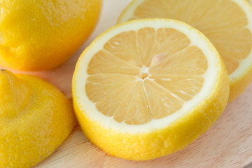 Obraz na płótnie Canvas Lemons on a wooden plate