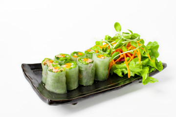 Fresh Tuna spring roll, traditional vietnamese food serve with mix vegetable in black plate on white background