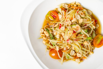 Traditional thai cuisine scipy green papaya salad on white background