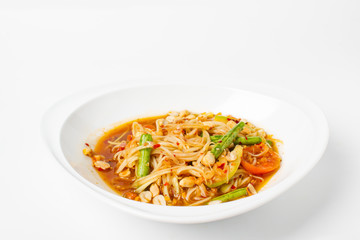 Traditional thai cuisine scipy green papaya salad on white background