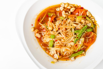 Traditional thai cuisine scipy green papaya salad on white background