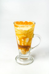 Desserts, A cup of yogurt and orange sauce with beans on white background