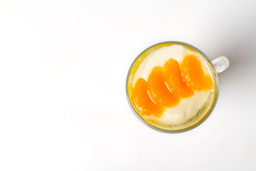 Desserts, A cup of yogurt and orange sauce with beans on white background