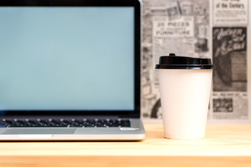 Laptop and coffee on wood table