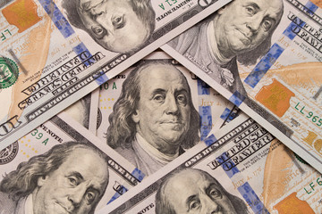 Hundred dollar bill with a smartphone on the table
