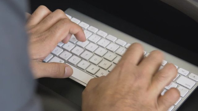 Hands typing on an apple computer keyboard
