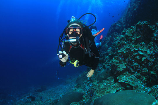 Female scuba diver underwater and fish
