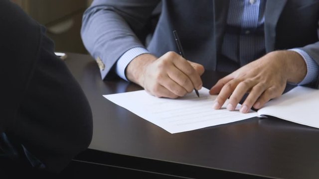 Lawyers signing and stamping contract