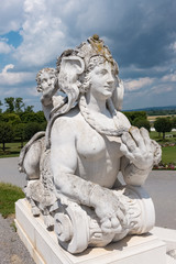 Fototapeta na wymiar Statue vor Wolken Himmel im Garten von Schloss Hof und barocken Blüten Pracht nahe der Grenze Slowakei