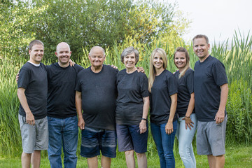 portrait of a senior couple with their five adult children. This large attractive family of adult...