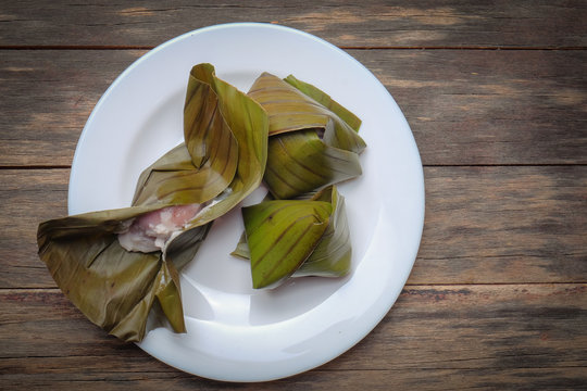 Flat lay of  koci the malay glutinous rice ball served in banana leaf