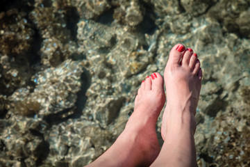 Woman's feet over water