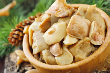 Pickled mushrooms in a wooden bowl