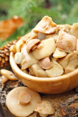Pickled mushrooms in a wooden bowl