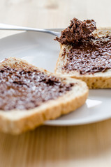 Pouring chocolate on a slice of bread