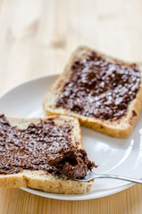 Pouring chocolate on a slice of bread