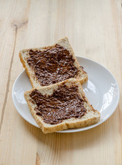 Pouring chocolate on a slice of bread