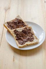 Pouring chocolate on a slice of bread