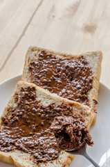 Pouring chocolate on a slice of bread