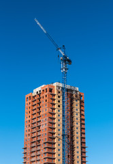 Fototapeta na wymiar tower crane on the construction of a high-rise building