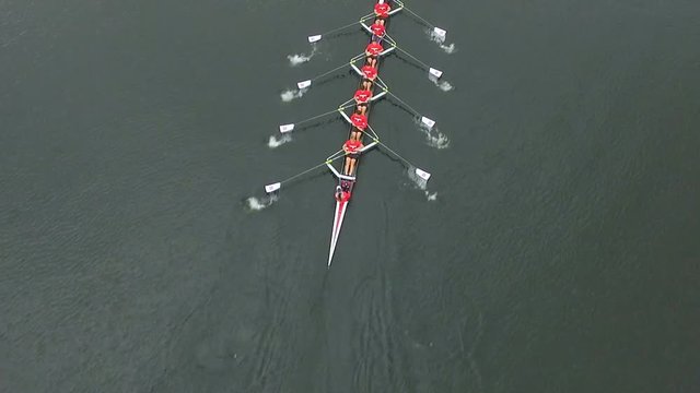 Overhead aerial of rowing team in boat rowing together