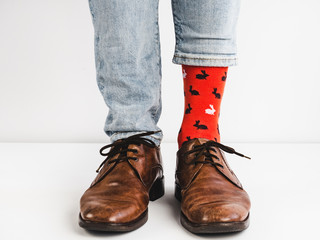 Bright, funny socks, vintage, brown shoes and man's legs on a white background. Fashion, style,...