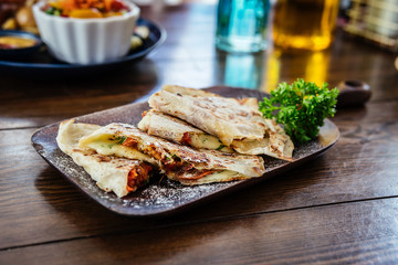 Mexican Quesadilla wrap with eggplant, tomato and sweet pepper and salsa.