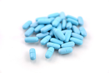 Oval blue tablets closeup on white background