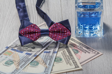 Fototapeta premium Man perfume, bow tie and dollar bills