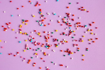 Texture background of pink color with sweet confetti