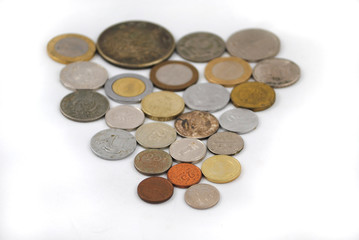 Old and new coins of different countries closeup on white background